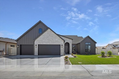 View of front of home featuring board and batten siding, driveway, and an attached garage