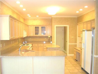 The kitchen preparation area has generous cabinet 
