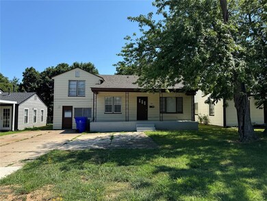 Tri-level home with a garage and a front lawn