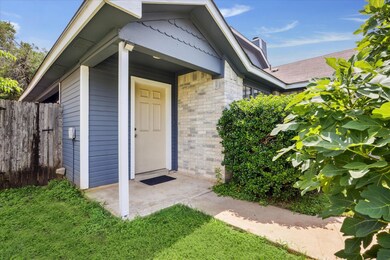 Entrance to property with brick siding and a chim
