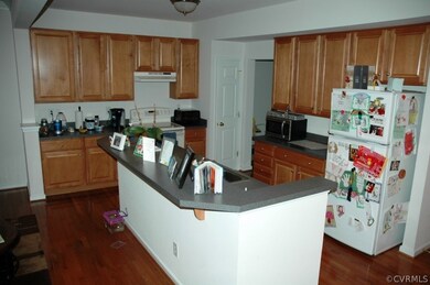Kitchen with hardwood floor, breakfast bar and oak
