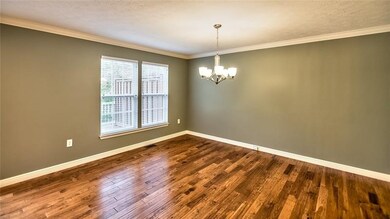 Formal Hardwood Floor Dining Room with Crown Moldi