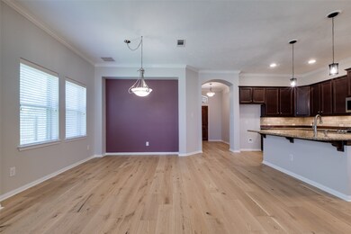 Newly installed wood flooring adds character to the open concept floor plan along with the crown molding installed throughout.
