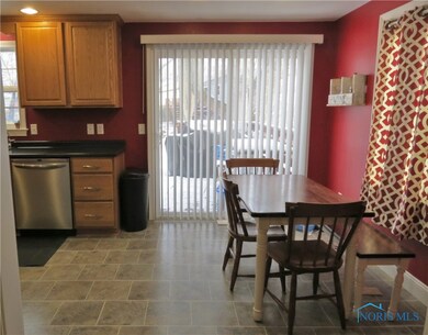 Kitchen/Dining with laminate flooring and slider d