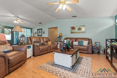 Living room featuring lofted ceiling, visible vent
