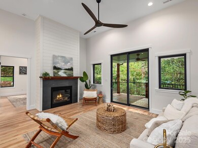 Open and bright living area to gather around the fireplace or flow effortlessly out to the expansive back porch