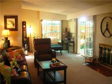 Living room with fireplace and lots of natural lig