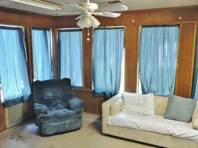 Great family room is surrounded by windows