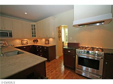 Kitchen - Designer kitchen features custom wood fl