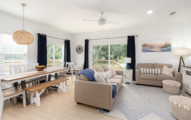 Living area featuring light wood finished floors, recessed lighting, and a ceiling fan