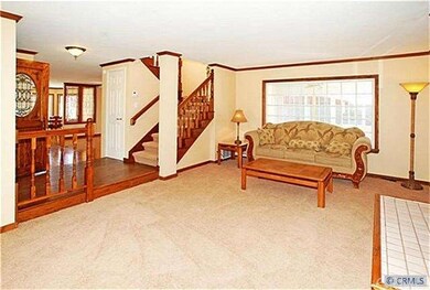 Living room towards stairway and formal raised ent