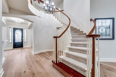 Elegant spiral staircase with chandelier is a grea