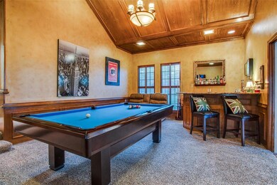 Great lower level entertaining space with plenty of space for games, movies, and karaoke! Complete with a bar, fridge and plenty of seating.