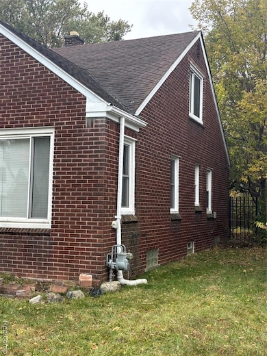View of property exterior with brick siding, a lawn, a chimney, and roof with shingles