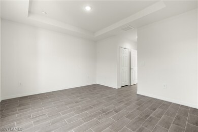 Empty room featuring a raised ceiling