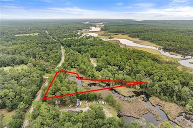 Aerial view of property's location featuring a nearby body of water and property boundaries highlighted