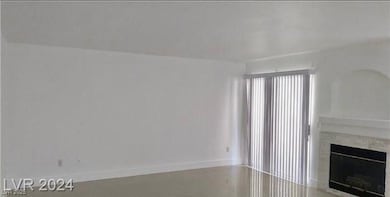 Unfurnished living room with a premium fireplace and baseboards