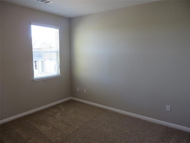 Unfurnished room featuring baseboards, visible ve