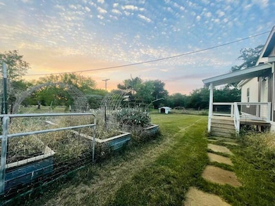 Yard at dusk featuring a yard and a vegetable gar