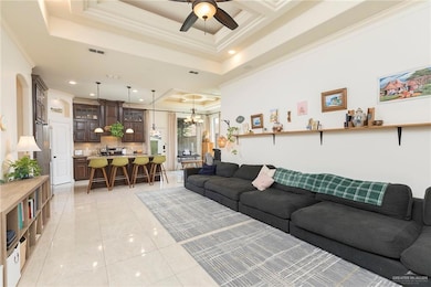 Living room open concept with crown molding, a high decorative ceiling, and recessed lighting