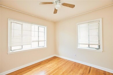 Unfurnished room featuring baseboards, wood finish