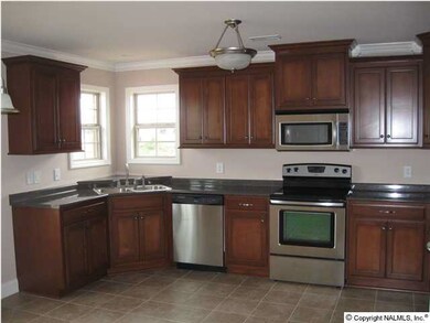 LARGE OPEN KITCHEN WITH WINDOWS FOR NATURAL LIGHT! CUSTOM MAPLE CABINETS, TILE FLOORING & MORE!