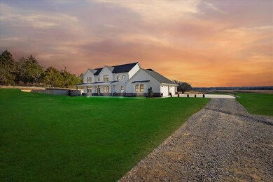 Back house at dusk with a lawn