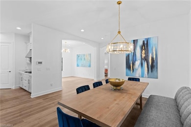 Dining area with an inviting chandelier, baseboard