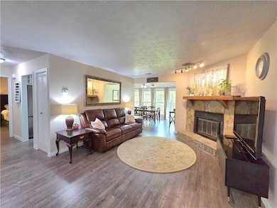 Living room with baseboards, wood finished floors,