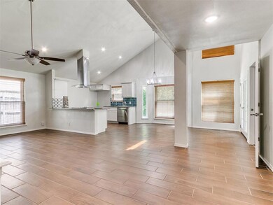 Unfurnished living room featuring a chandelier, a 