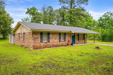 Single story home featuring a front lawn, brick si