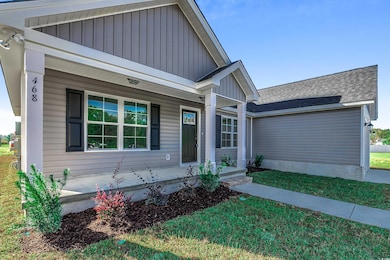 View of front of home with a front lawn and a porc
