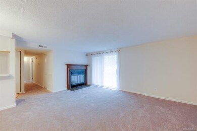 Living room with wood burning fireplace and slidin