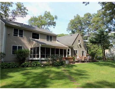 Exterior Back. nicely landscaped lot with rear woo