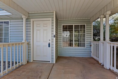 View of exterior entry featuring covered porch