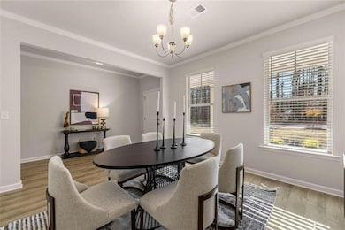 Dining space with crown molding, visible vents, a 