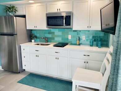 Kitchen with stainless steel appliances, white cab