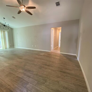 Unfurnished room featuring vaulted ceiling, wood-