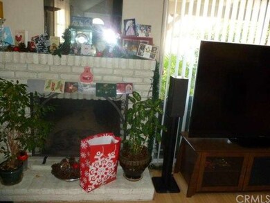 Brick fireplace in large living room.  Notice wood type flooring. Beautiful!
