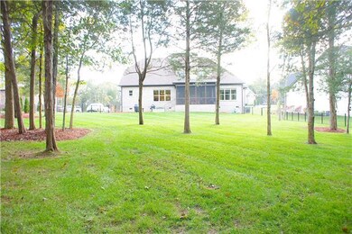 Relaxing covered and screened in porch, which will be shaded by the trees in the large, 1/2 acre back yardl. 