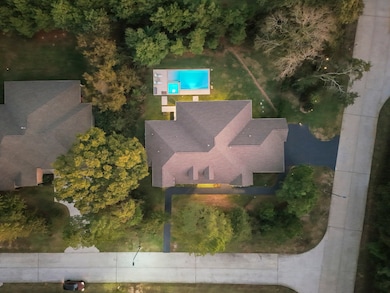 Drone view showcases the generous lot size, private placement and surrounding mature trees.