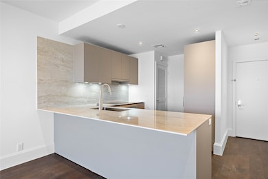 Residence is entirely hardscape, including wide plank engineered hardwood and large format tile floors.