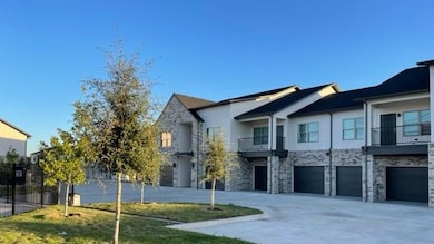 View of property exterior featuring a garage and a