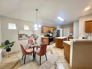 Dining area featuring lofted ceiling, light tile 