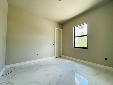 Spare room with baseboards and light marble finish