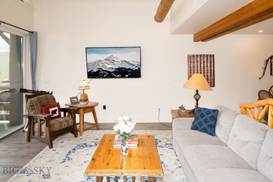Living room with beamed ceiling and hardwood / woo