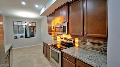 Kitchen featuring light stone counters, a notable