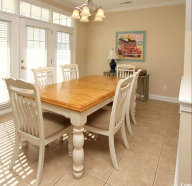 Dining room with light tile patterned floors, orna