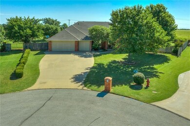 View of front of home with a garage and a front la