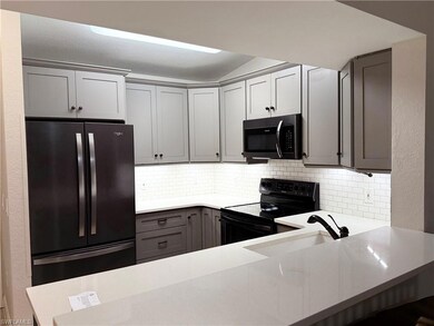 Kitchen featuring light countertops, tasteful back